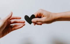 Two hands, one offering a paper heart to the other. Image by Kelly Sikkema, from Unsplash